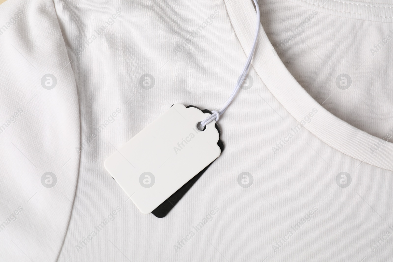 Cardboard tags on white t-shirt, top view Photo of Cardboard tags on white t-shirt, top view