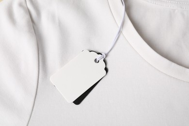 Photo of Cardboard tags on white t-shirt, top view
