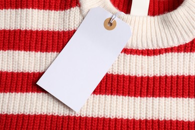 Photo of Cardboard tag on knitted sweater, top view