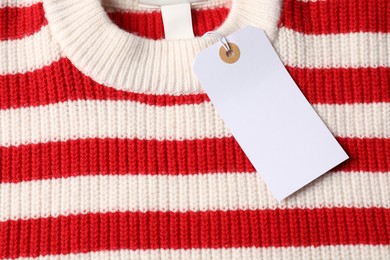 Photo of Cardboard tag on knitted sweater, top view
