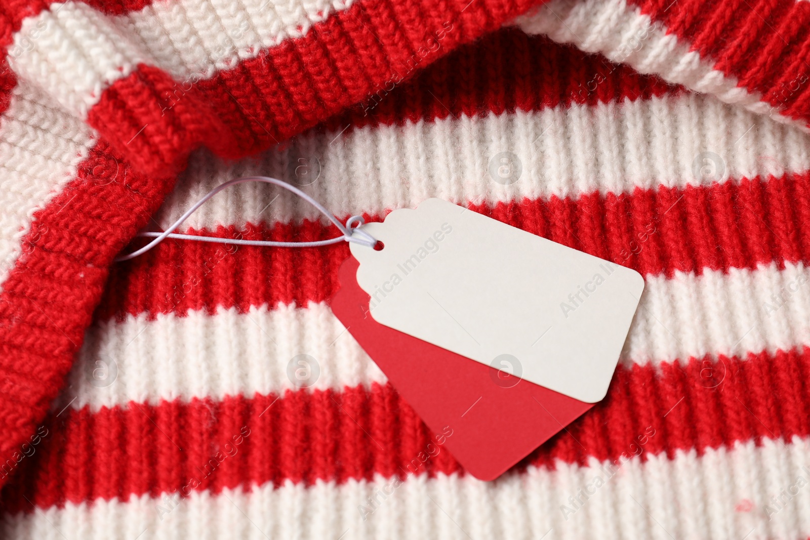 Cardboard tags on knitted sweater, above view Photo of Cardboard tags on knitted sweater, above view