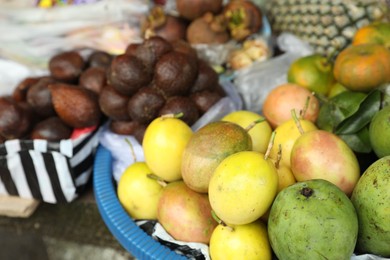 Photo of Different fresh exotic fruits at market, closeup