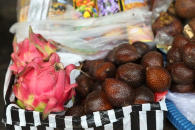 Photo of Different fresh exotic fruits at market, closeup