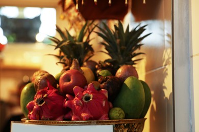 Photo of Different fresh exotic fruits in basket at market, closeup