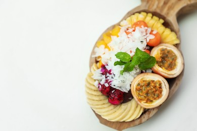 Photo of Different fresh fruits on white table, above view. Space for text