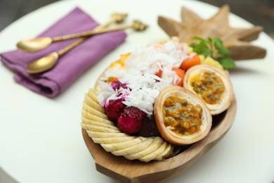 Photo of Different fresh fruits on white table, closeup