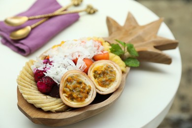 Photo of Different fresh fruits on white table, closeup