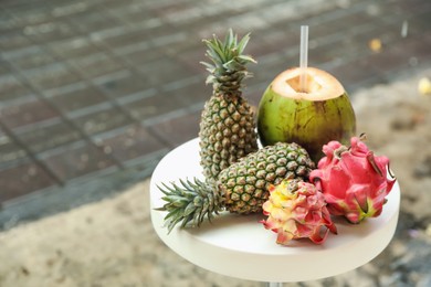 Photo of Different fresh fruits on white table outdoors, space for text