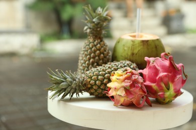 Photo of Different fresh fruits on white table outdoors, closeup. Space for text