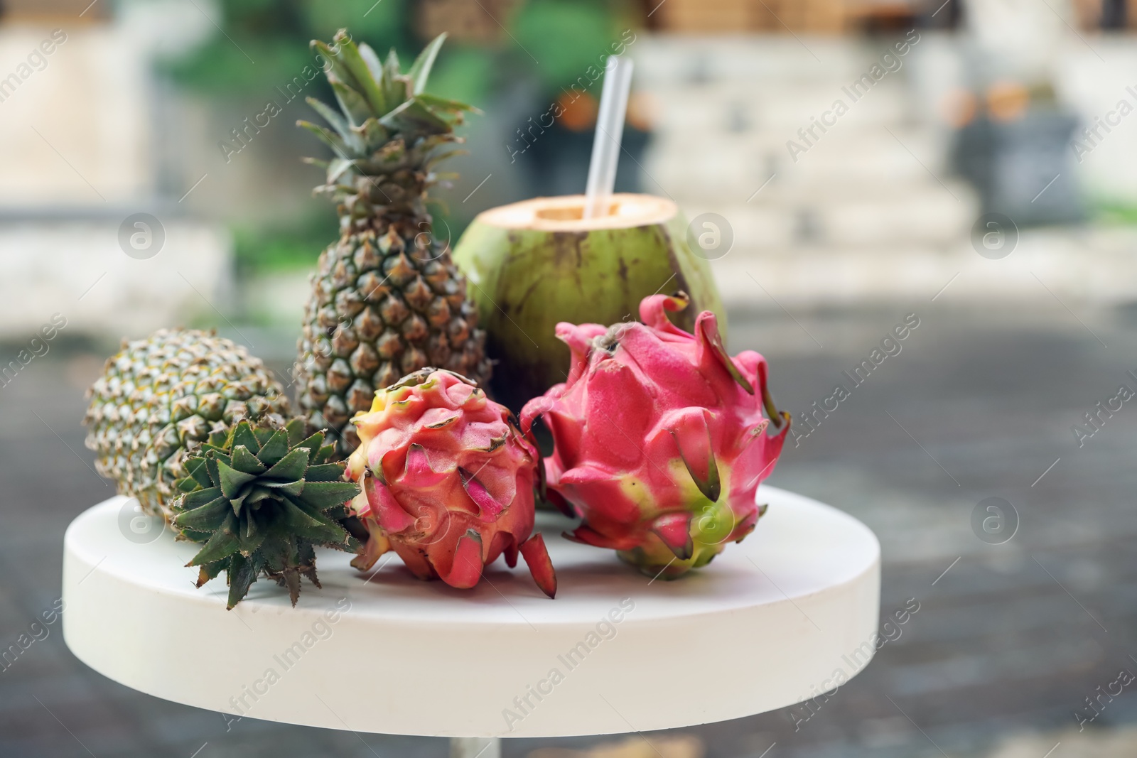 Different fresh fruits on white table outdoors, closeup. Space for text Photo of Different fresh fruits on white table outdoors, closeup. Space for text
