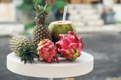 Photo of Different fresh fruits on white table outdoors, closeup. Space for text
