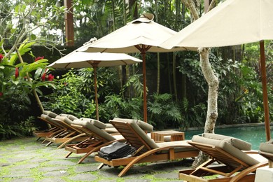 Photo of Empty sunbeds near pool at luxury resort