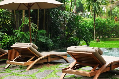 Photo of Empty sunbeds near pool at luxury resort