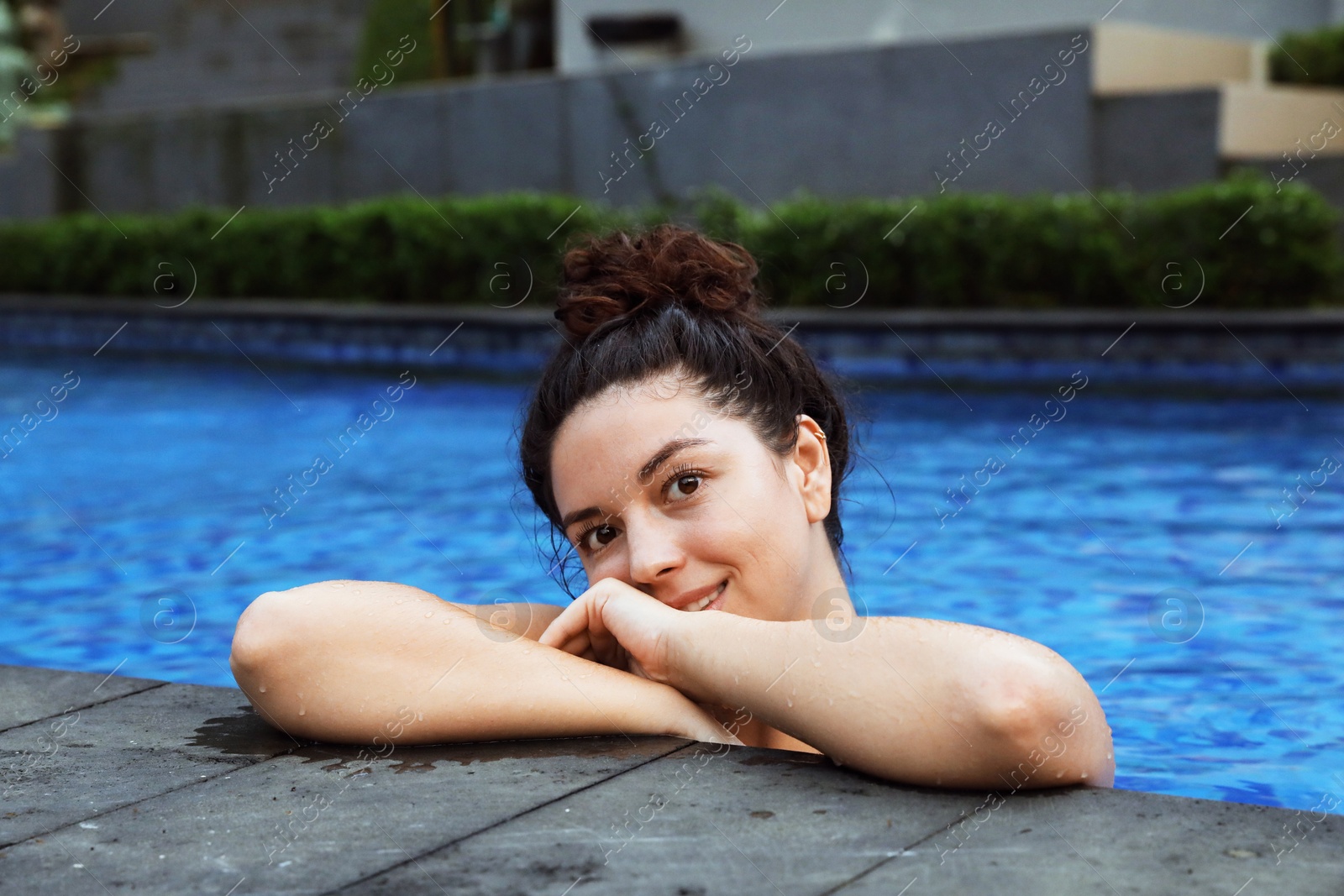 Happy woman relaxing in swimming pool outdoors Photo of Happy woman relaxing in swimming pool outdoors