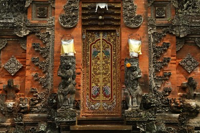 Photo of Bali, Indonesia - May 15, 2025: Entrance of temple with beautiful Dvarapala statues outdoors