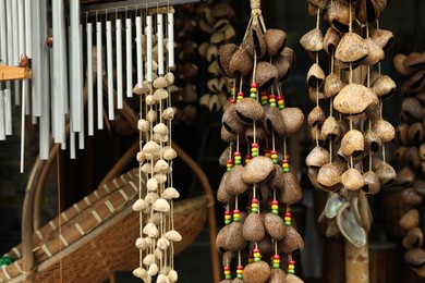 Photo of Different wind chimes in outdoor souvenir shop