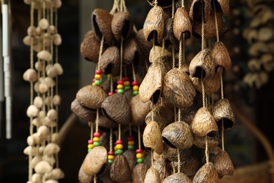 Photo of Different wind chimes in outdoor souvenir shop, closeup