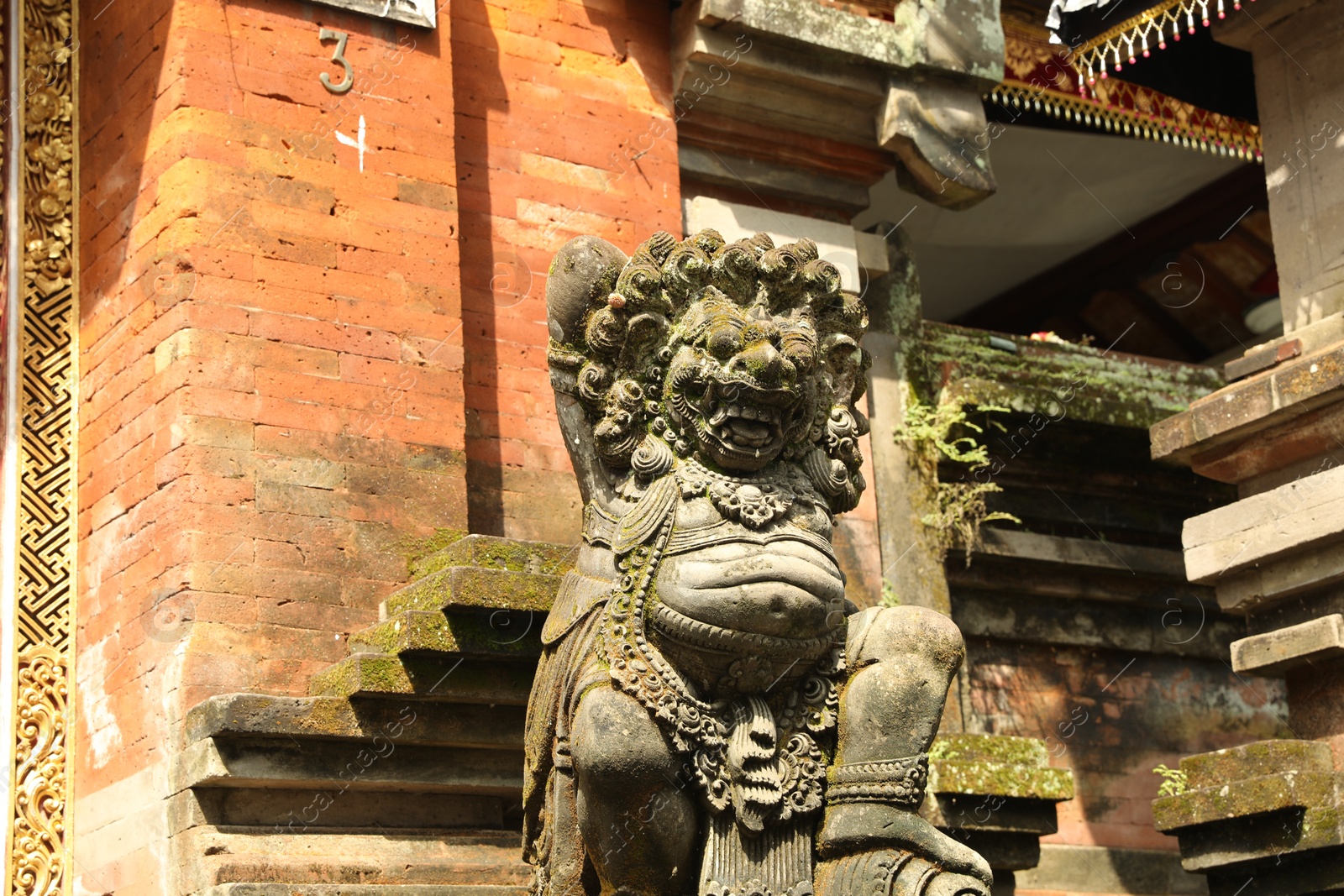 Photo of Bali, Indonesia - May 15, 2025: Beautiful ancient sculpture on city street, low angle view