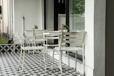 Photo of Cozy terrace of cafe with tables and chairs