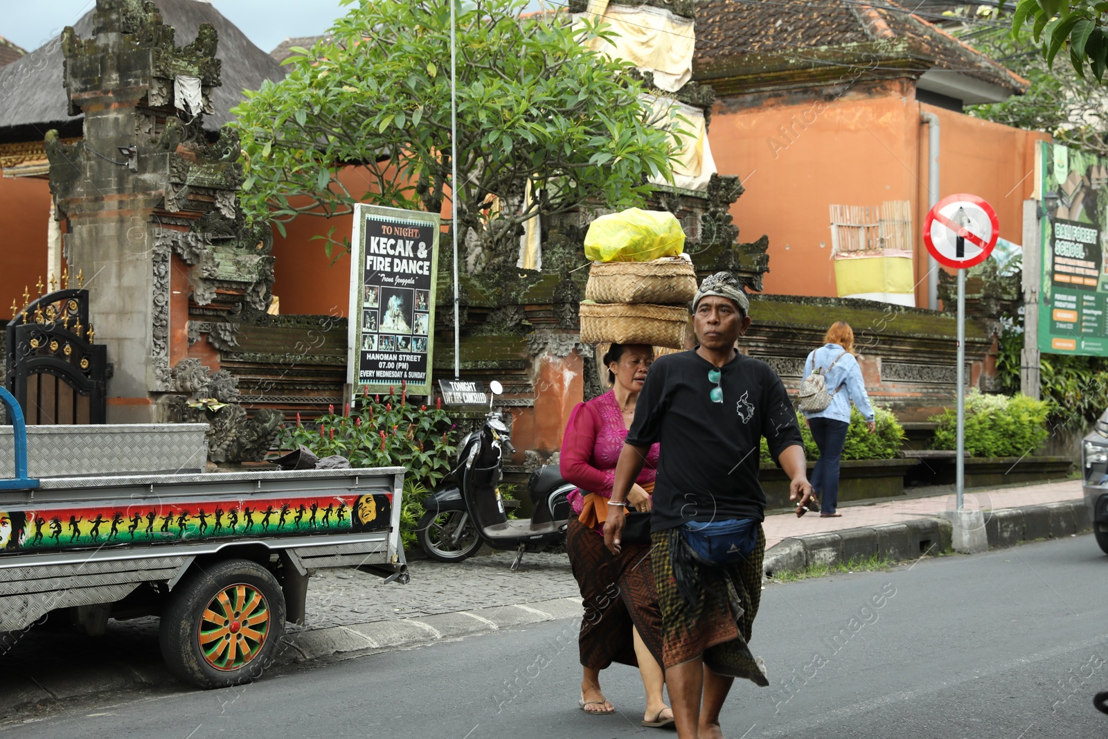 Bali, Indonesia - May 15, 2025: Locals in traditional clothes walking on street Photo of Bali, Indonesia - May 15, 2025: Locals in traditional clothes walking on street