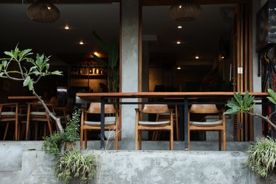Photo of Cozy terrace of cafe with tables, chairs and decor