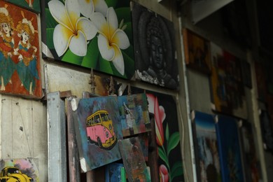 Photo of Bali, Indonesia - May 15, 2025: Different pictures on wall indoors, closeup