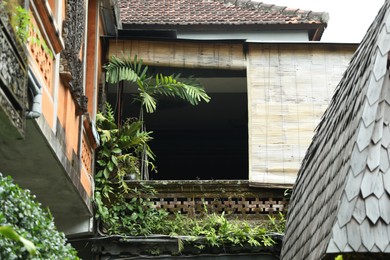Photo of Beautiful building covered with green plants outdoors, low angle view