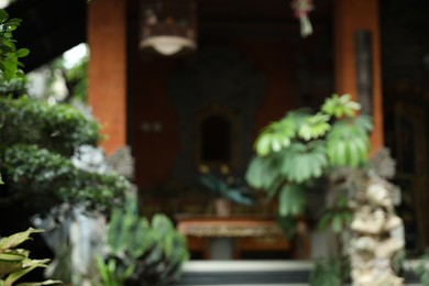 Photo of Blurred view of building and green plants outdoors