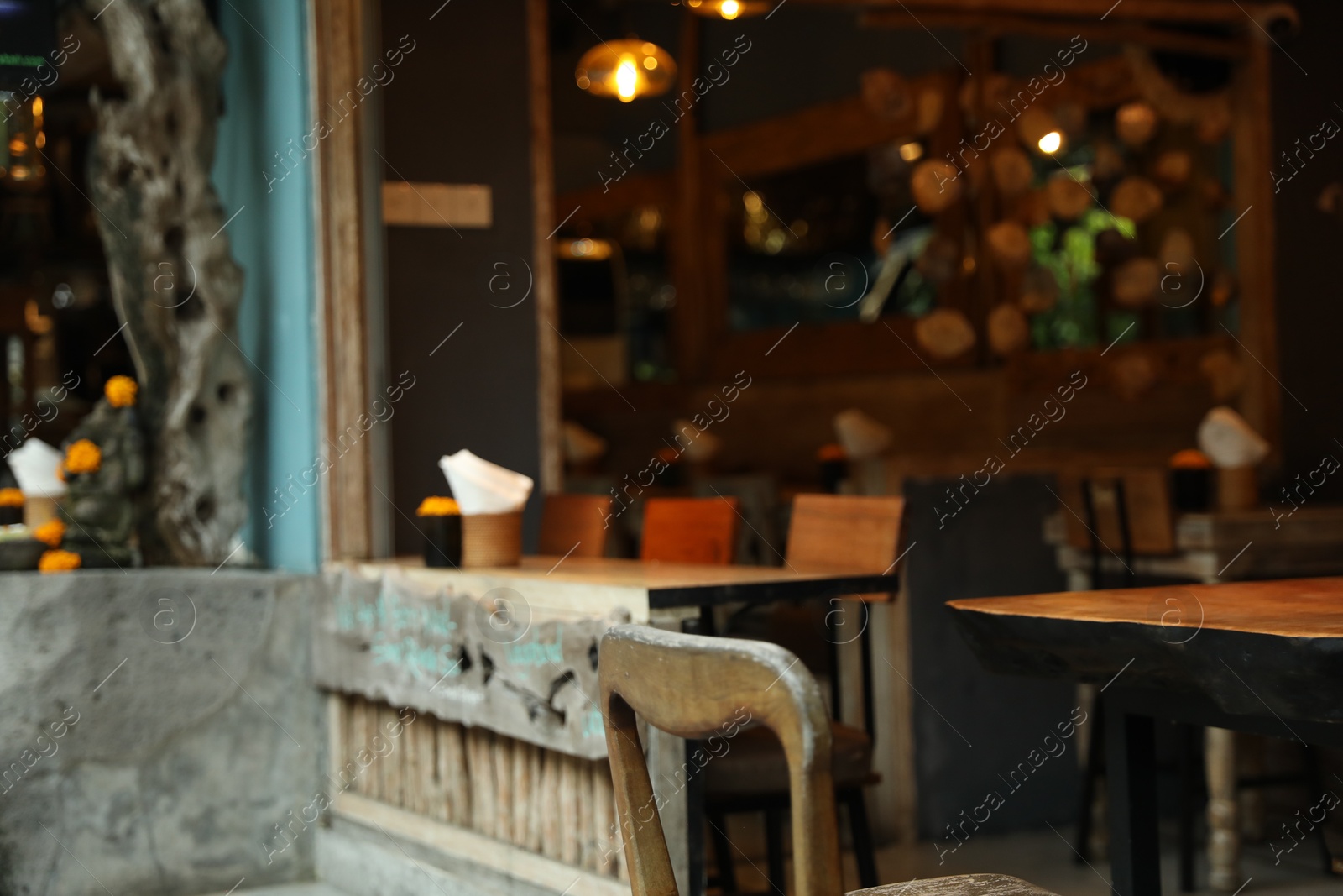 Tables, chairs and decor in cozy cafe interior, closeup Photo of Tables, chairs and decor in cozy cafe interior, closeup