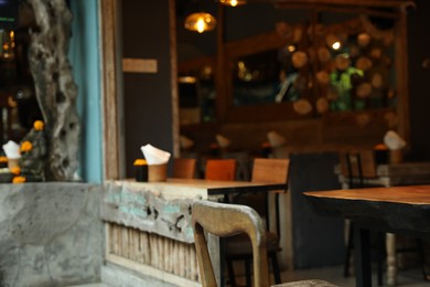 Photo of Tables, chairs and decor in cozy cafe interior, closeup
