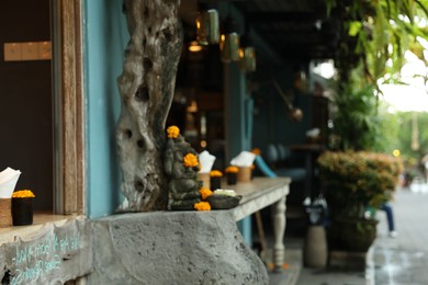 Photo of Beautiful Ganesha statue with ornament on cafe counter outdoors