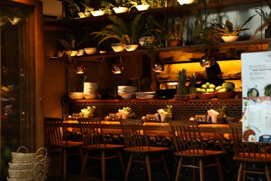 Photo of Many tables, table and counter in cozy cafe interior