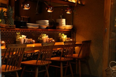 Photo of Many tables, table and counter in cozy cafe interior