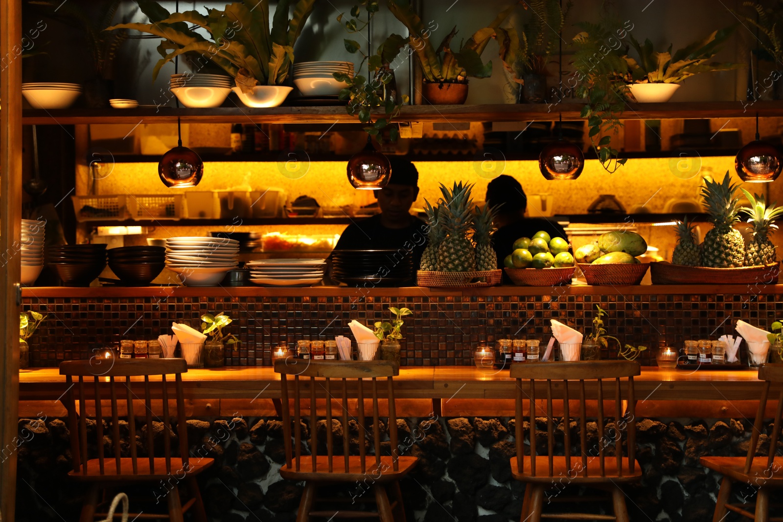 Bali, Indonesia - May 15, 2025: Workers at counter in stylish cafe Photo of Bali, Indonesia - May 15, 2025: Workers at counter in stylish cafe