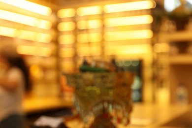 Photo of Stylish furniture and decor in cozy cafe interior, blurred view