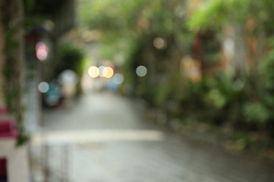 Photo of Blurred view of street with pathway and green plants