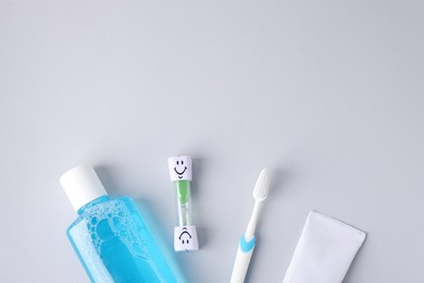 Photo of Different oral care products on light grey background, flat lay. Space for text