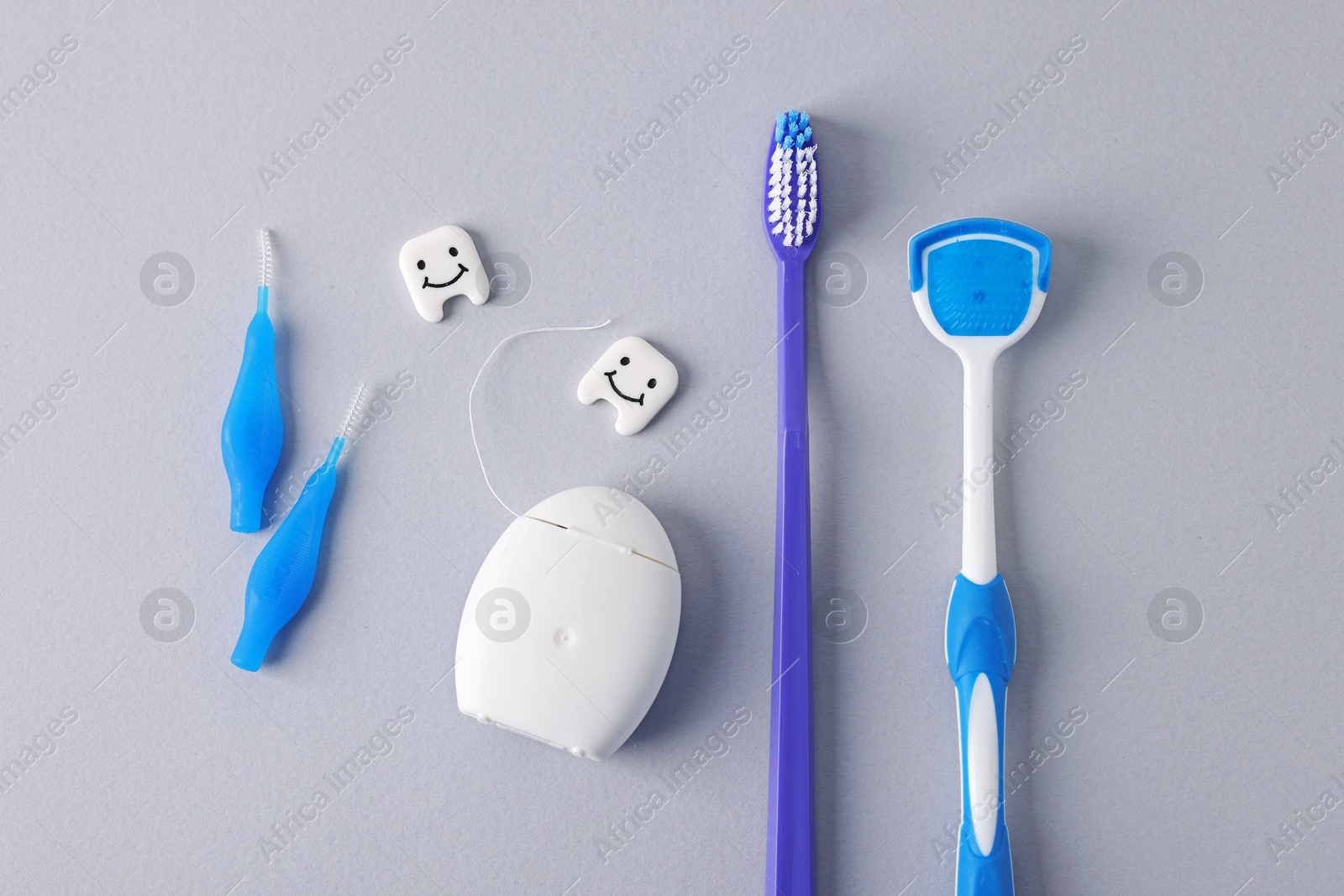 Different oral care products and teeth models on light grey background, flat lay Photo of Different oral care products and teeth models on light grey background, flat lay
