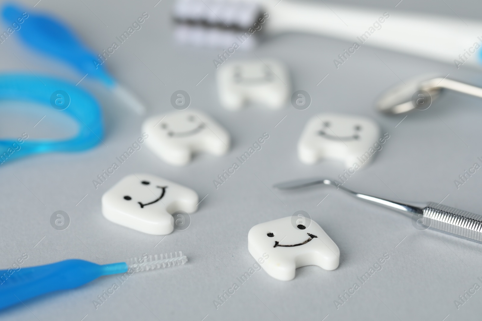 Different oral care products and teeth models on light grey background, closeup Photo of Different oral care products and teeth models on light grey background, closeup
