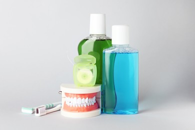 Photo of Different oral care products on light grey background