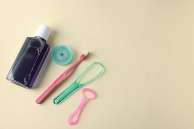 Photo of Different oral care products on beige background, flat lay. Space for text