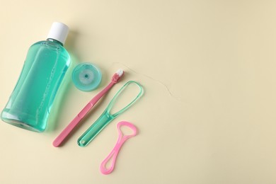 Photo of Different oral care products on beige background, flat lay. Space for text