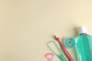 Photo of Different oral care products on beige background, flat lay. Space for text