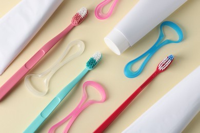 Photo of Different oral care products on beige background, flat lay