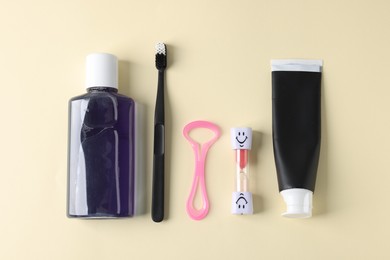 Photo of Different oral care products on beige background, flat lay