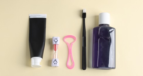 Photo of Different oral care products on beige background, flat lay