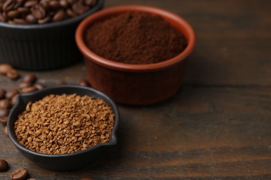 Photo of Different types of instant coffee and beans in bowls on wooden table, closeup