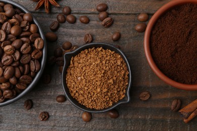 Photo of Different types of instant coffee, beans and spices on wooden table, flat lay