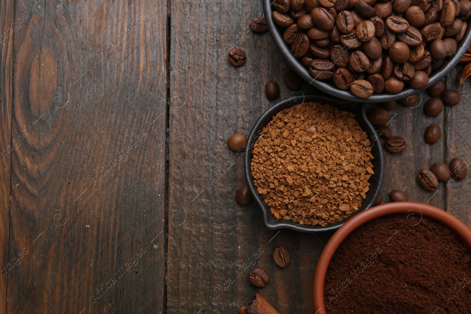 Different types of instant coffee and beans on wooden table, flat lay. Space for text Photo of Different types of instant coffee and beans on wooden table, flat lay. Space for text