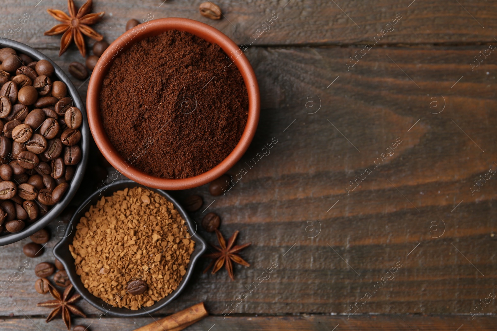 Different types of instant coffee, beans and spices on wooden table, flat lay. Space for text Photo of Different types of instant coffee, beans and spices on wooden table, flat lay. Space for text